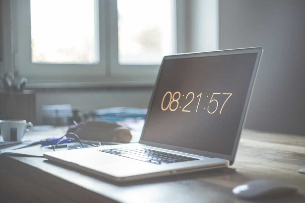 Computer on a desk featuring timer clock